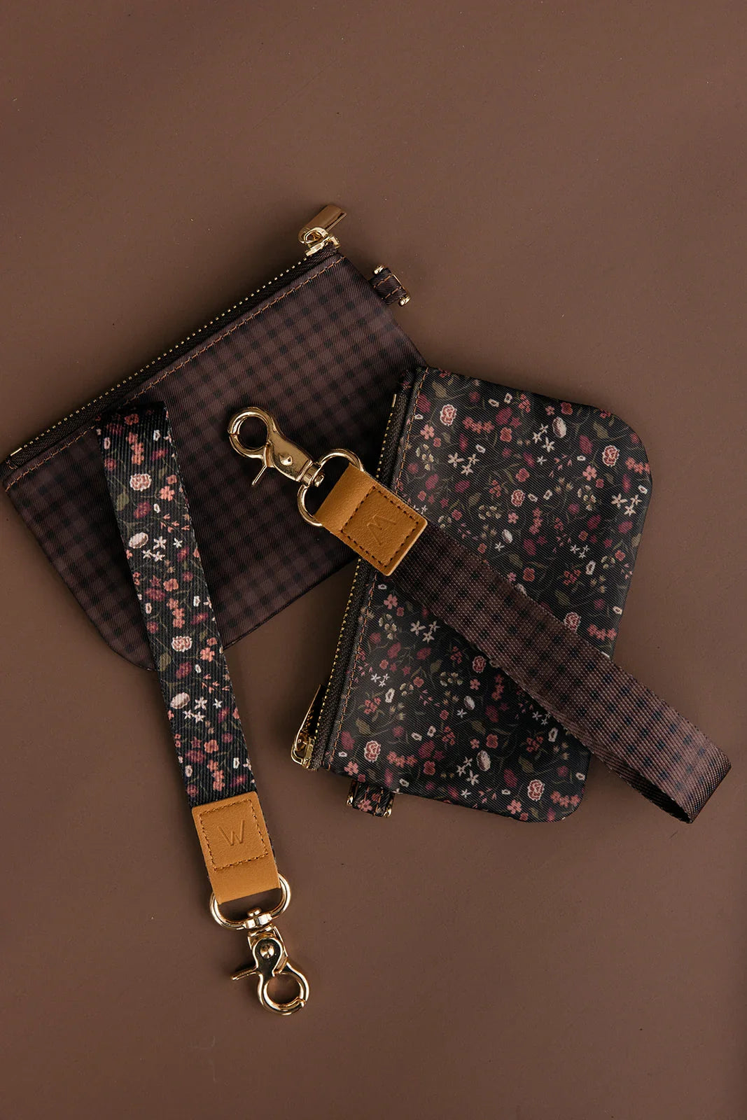 Floral zip wrist pouch and matching card pouch with tan leather tabs, gold rings.