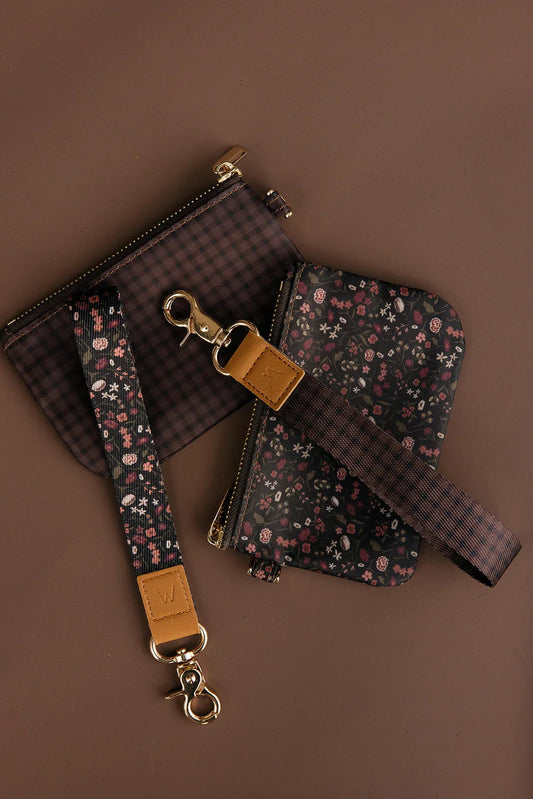 Floral zip wrist pouch and matching card pouch with tan leather tabs, gold rings.