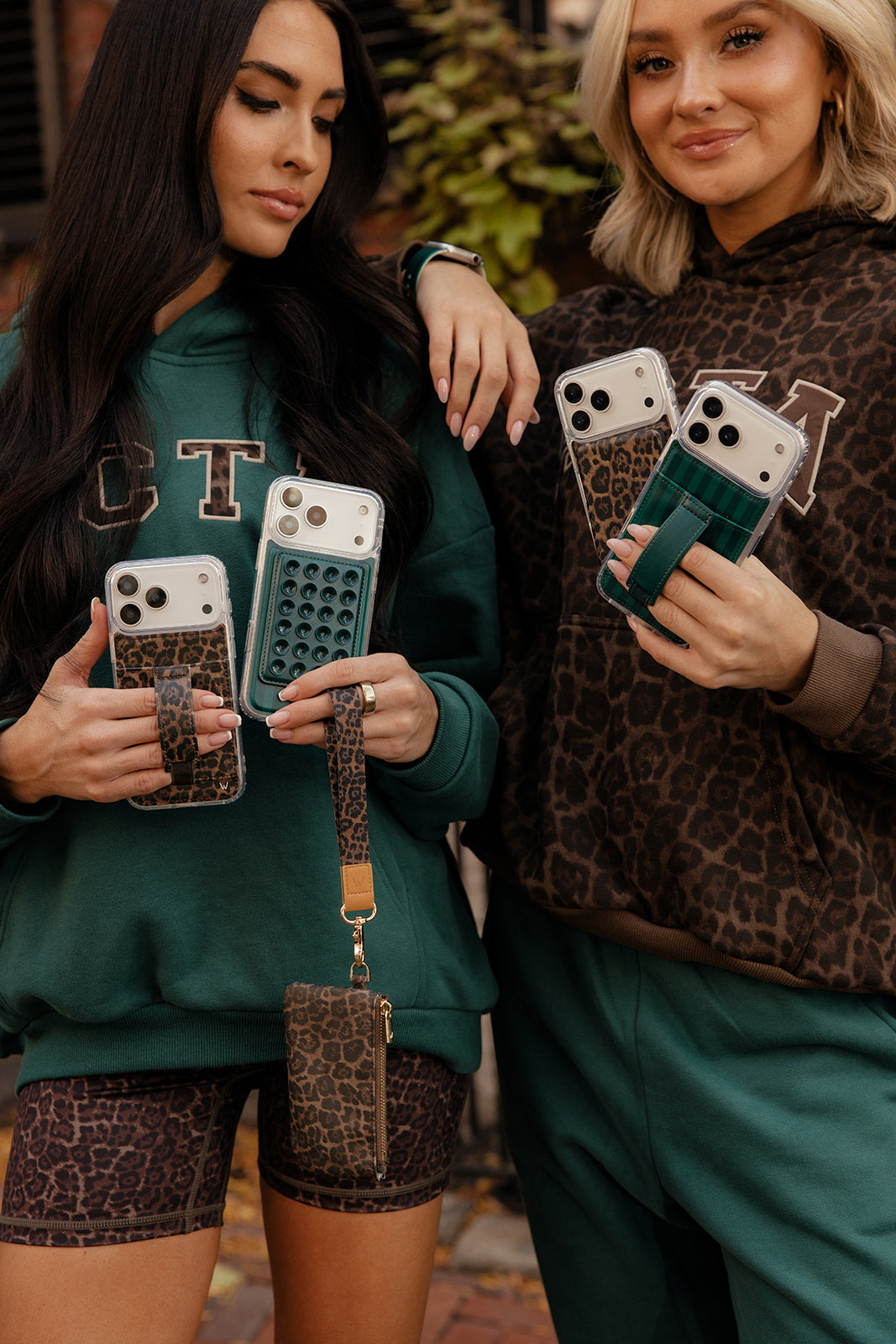 Leopard-print zipper pouch with chain strap, held by model