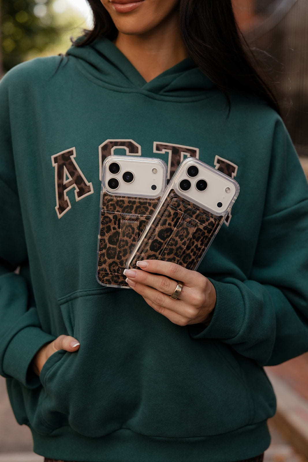 Leopard-pattern magnetic phone wallet with card slots shown on a phone back