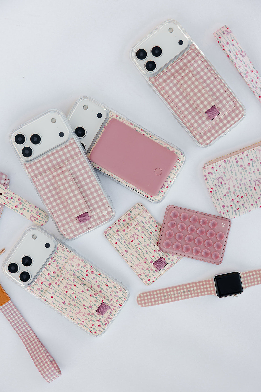Set of pastel phone cases with pink check, rose vine, and dot pop design