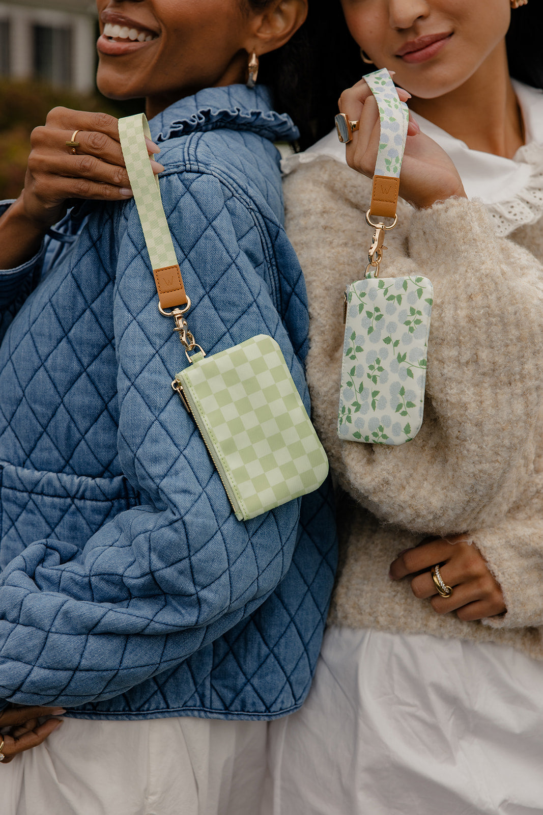 Green check and floral zip pouches with gold hardware on shoulder straps.