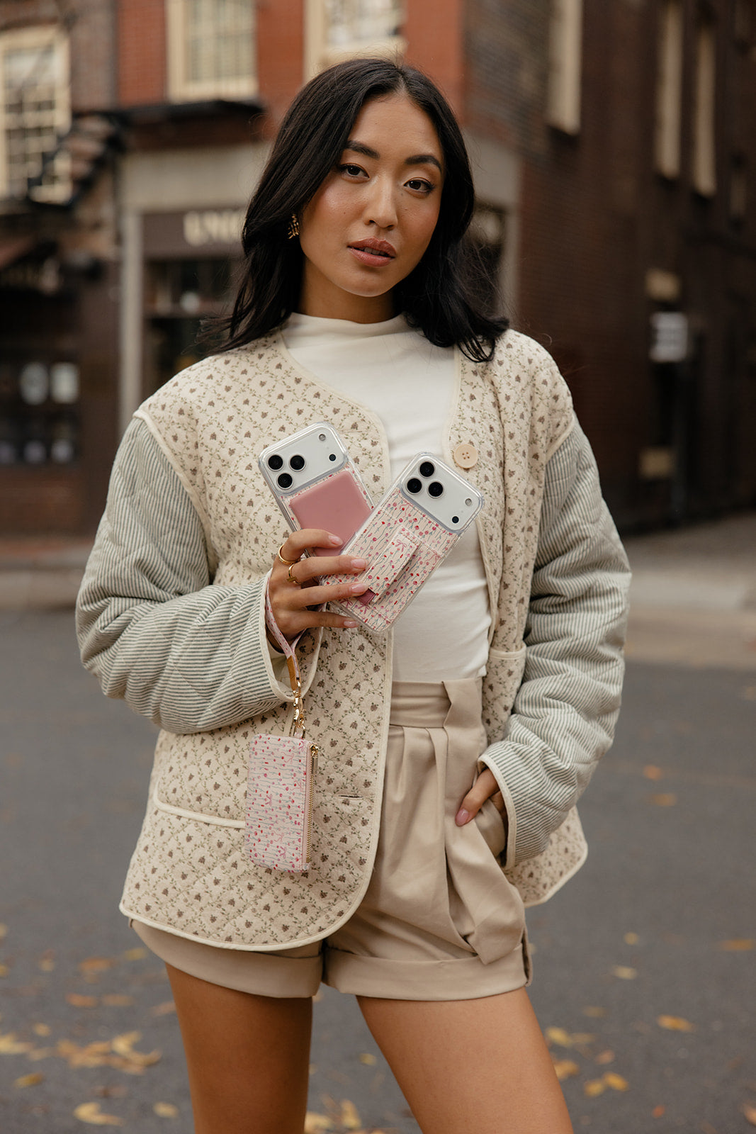 Cream jacket with two pastel phone cases: one rose garden, one gingham, with straps
