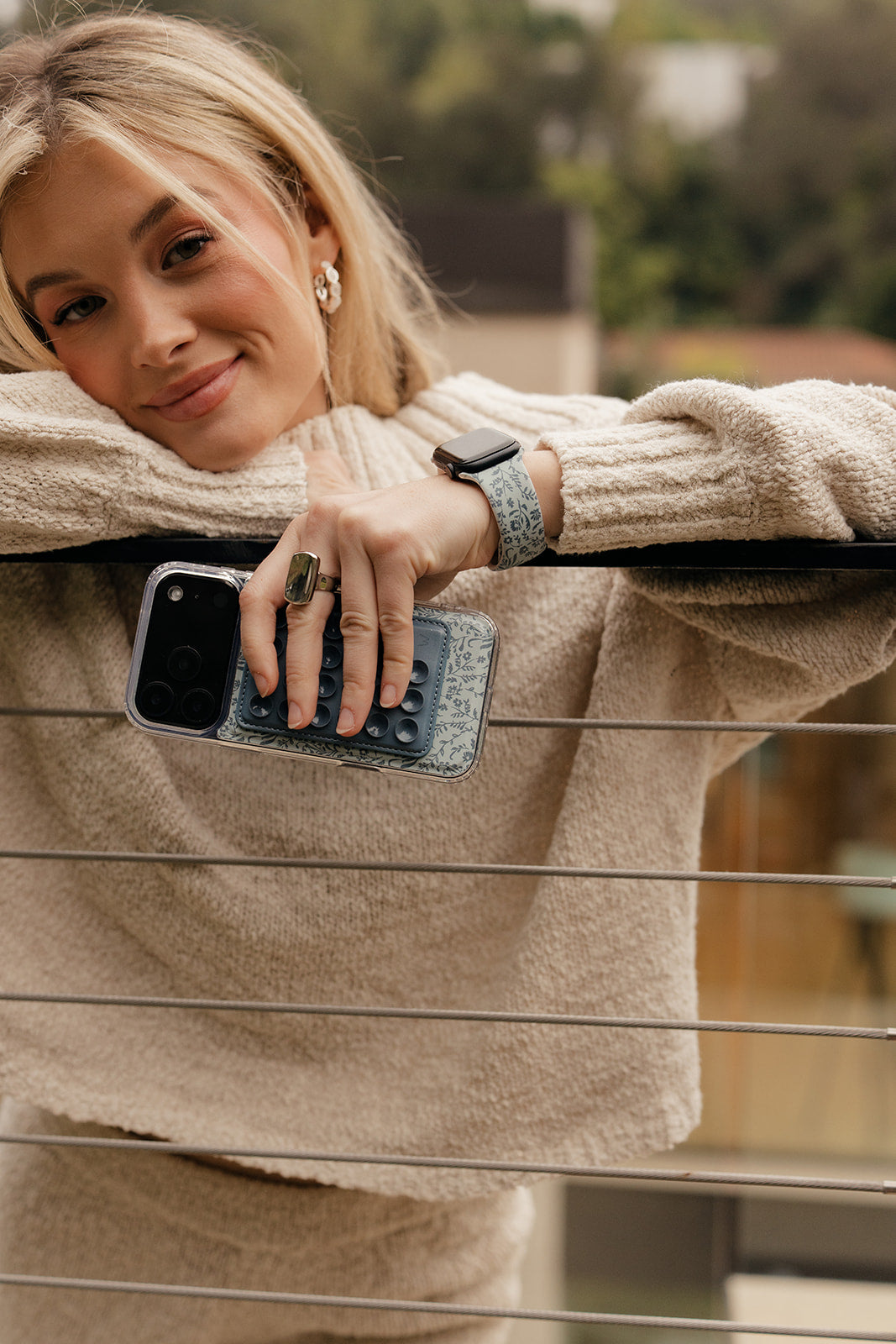 Light blue botanical watch band on wrist with black smartwatch