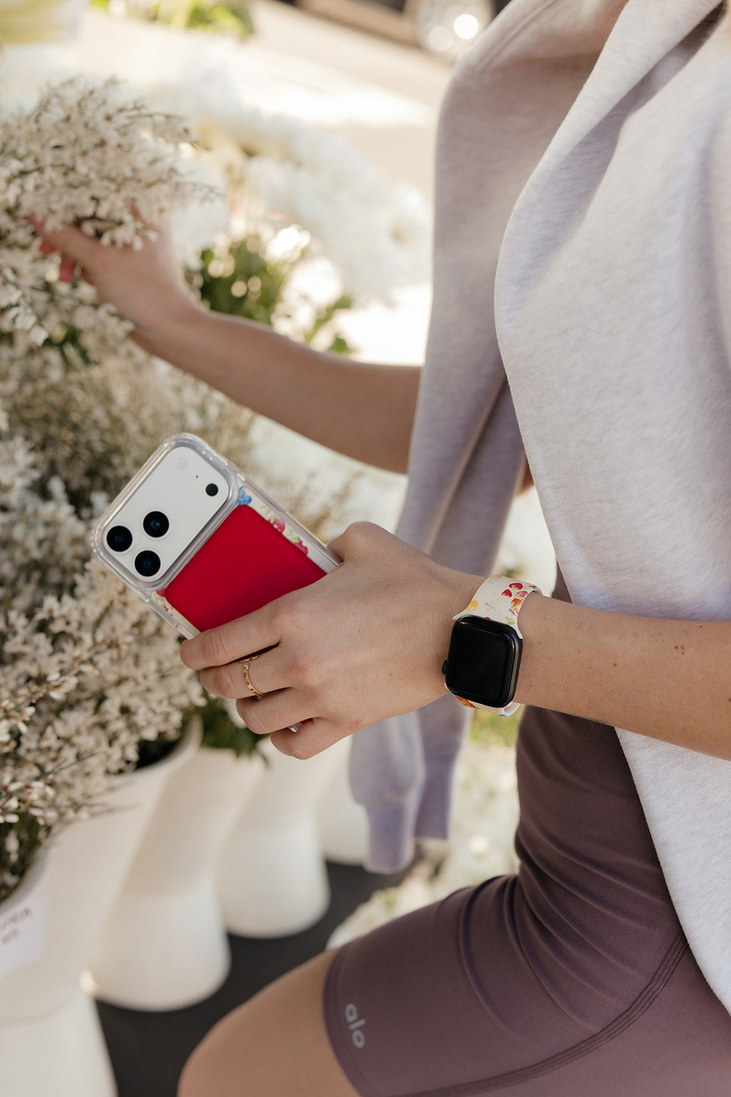 Floral watch band on wrist with black smartwatch face