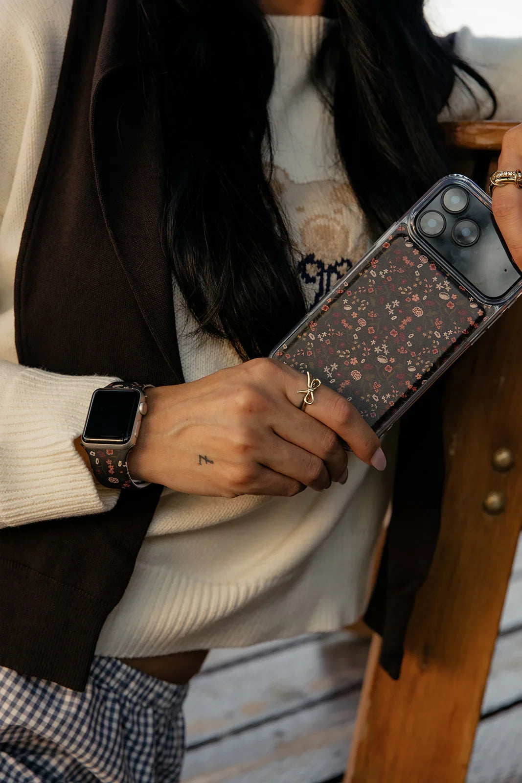 Clear magnetic iPhone case with dark floral panel and wrist strap