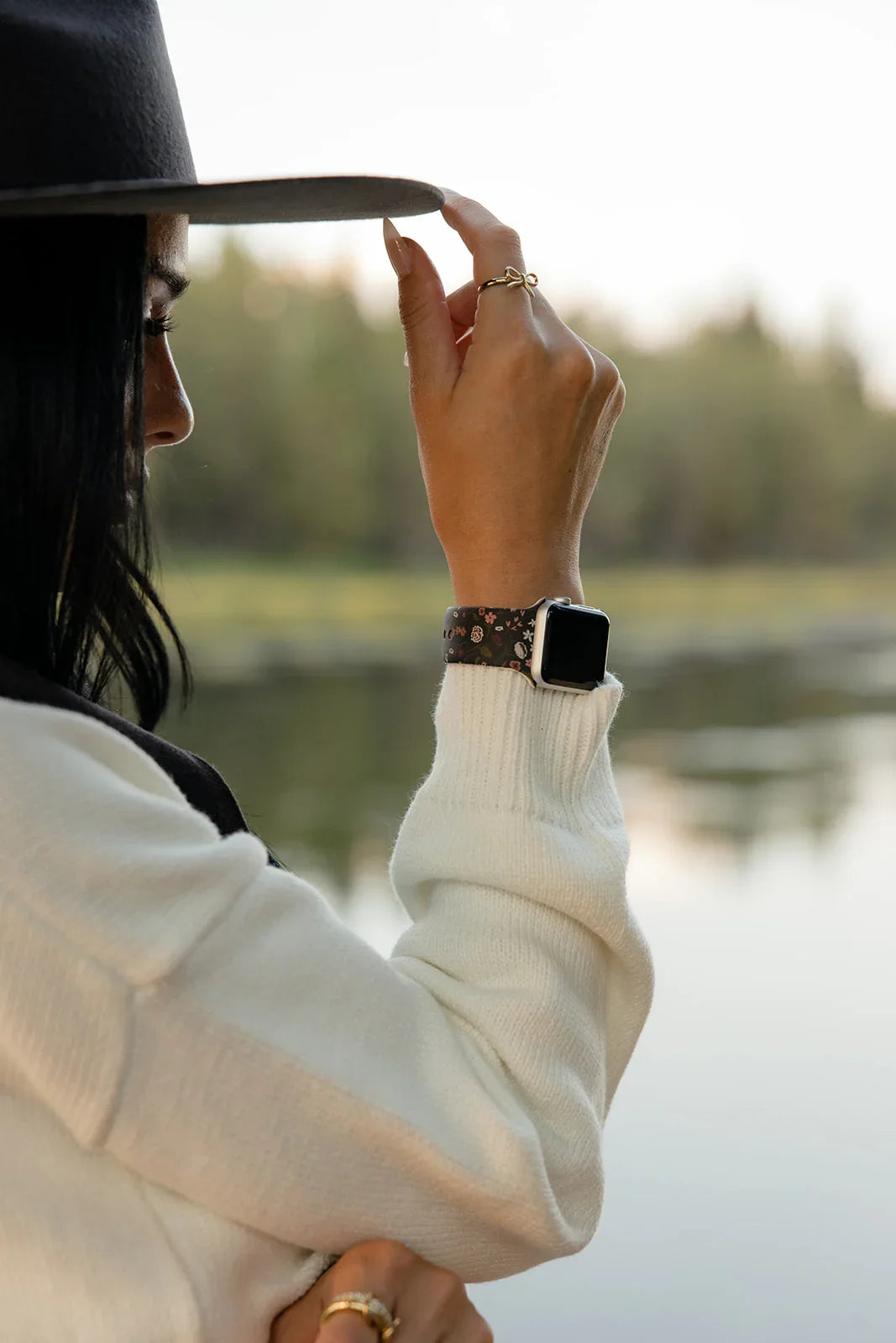 Floral watch band on wrist with square smartwatch case and silver clasp