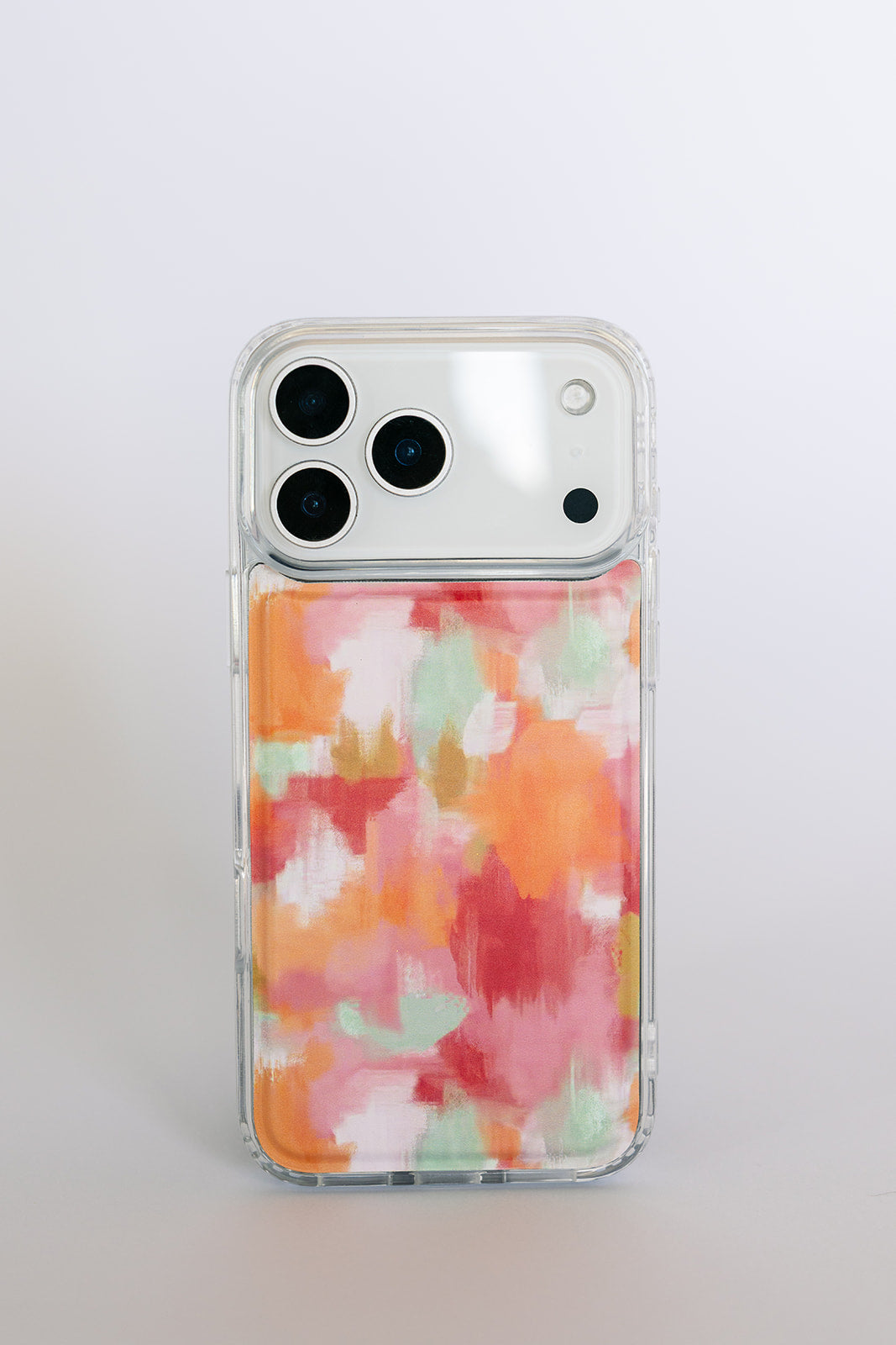 Clear magnetic phone case with orange-pink watercolor waves, front camera cutouts