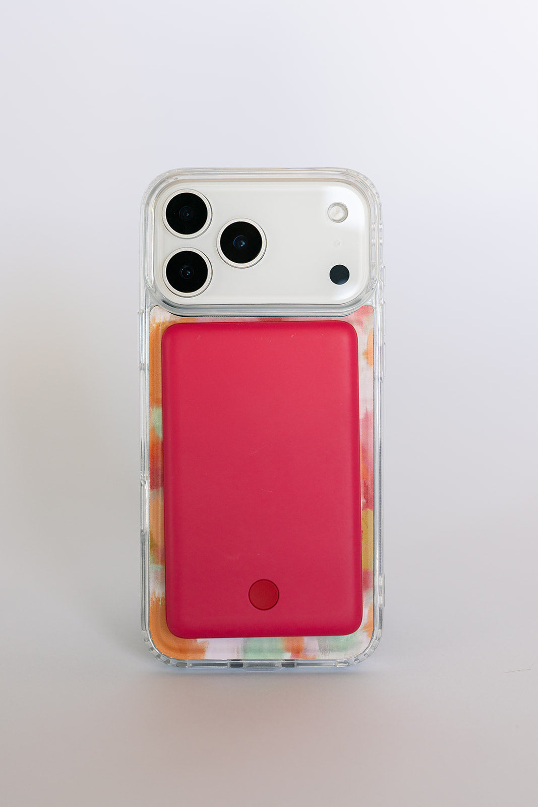 Clear magnetic phone case with orange-pink watercolor trim and red backing panel