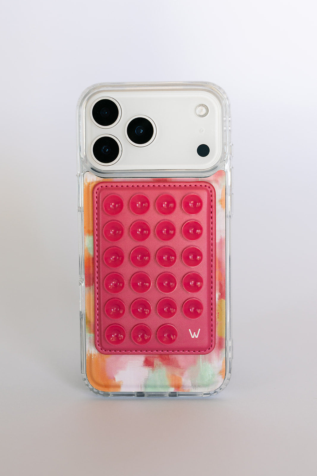 Clear magnetic phone case with orange-pink watercolor waves and pink studded card