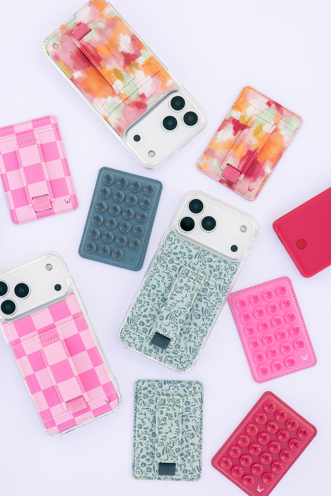 Multiple colorful phone cases including teal botanical design with gray strap tab