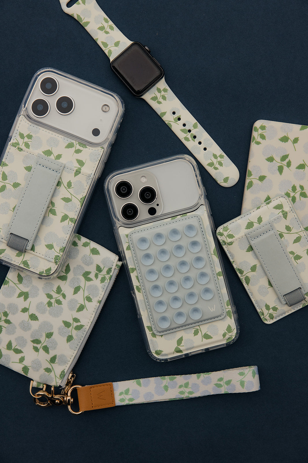 Multiple floral magnetic wallets with gray strap closures and bubble-texture panels