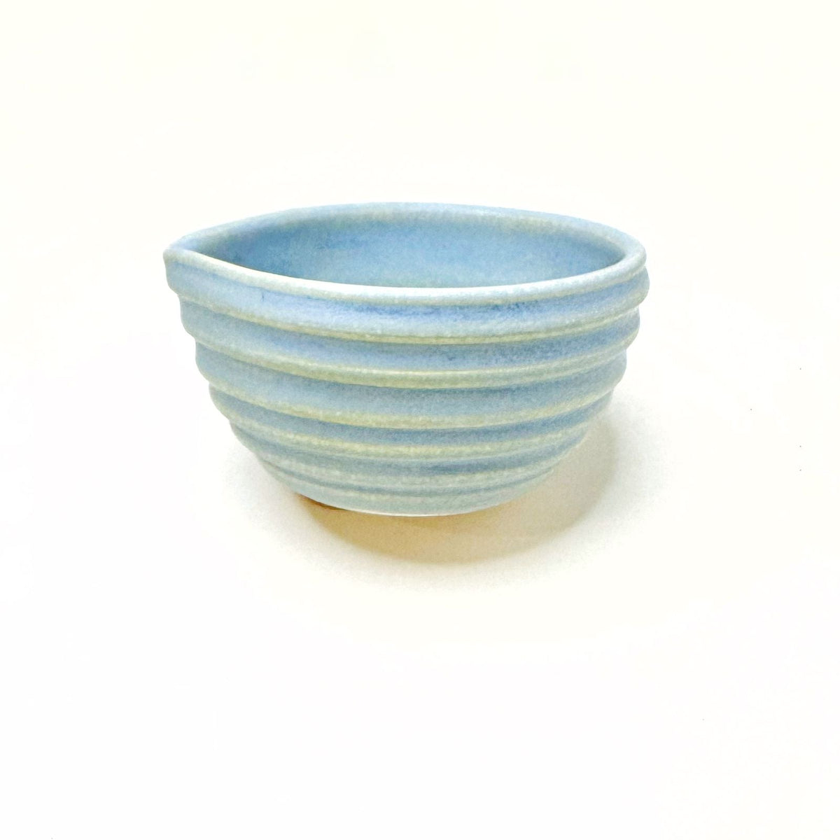 Blue ceramic matcha bowl with ribbed banded design and rounded interior