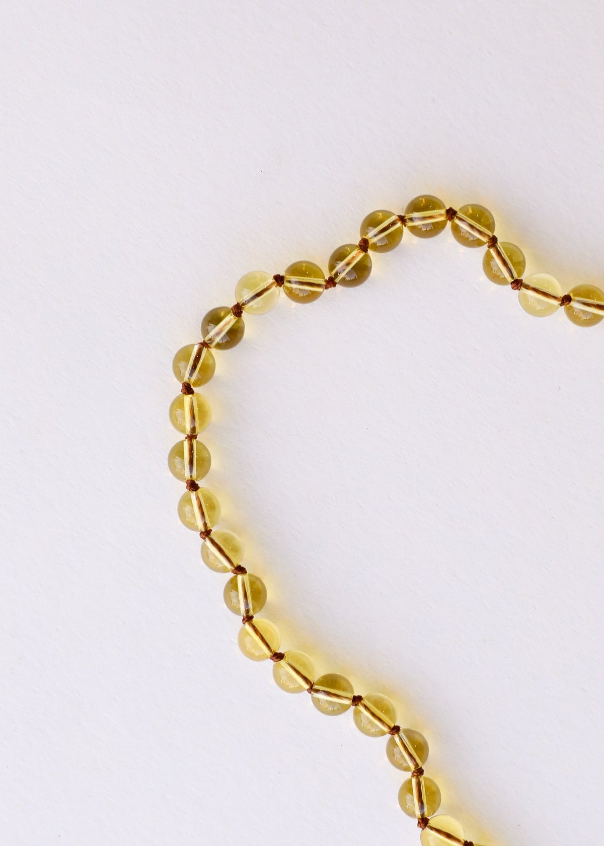 Close-up citrine gemstone beaded bracelet, yellow glassy oval beads