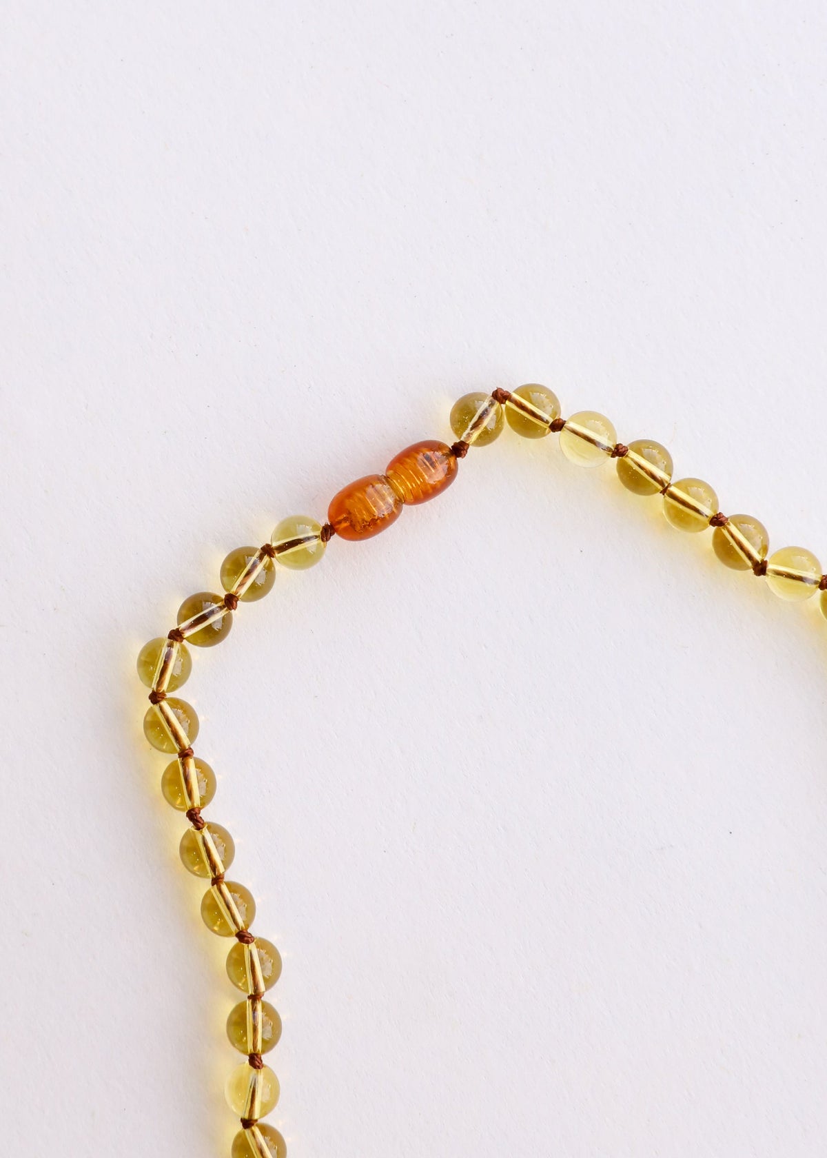Citrine beaded bracelet with clear yellow oval beads and orange cylindrical spacer
