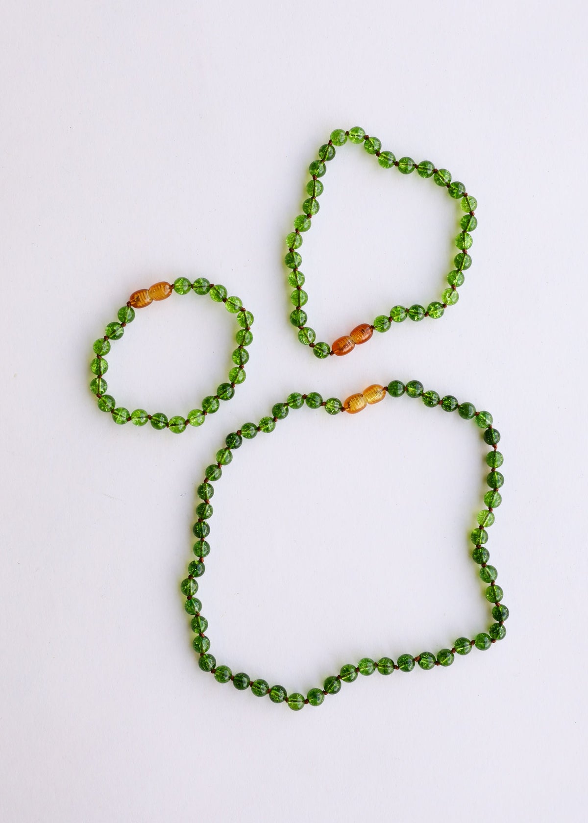 Gemstone bead anklet and bracelet set with green peridot beads and amber orange accents