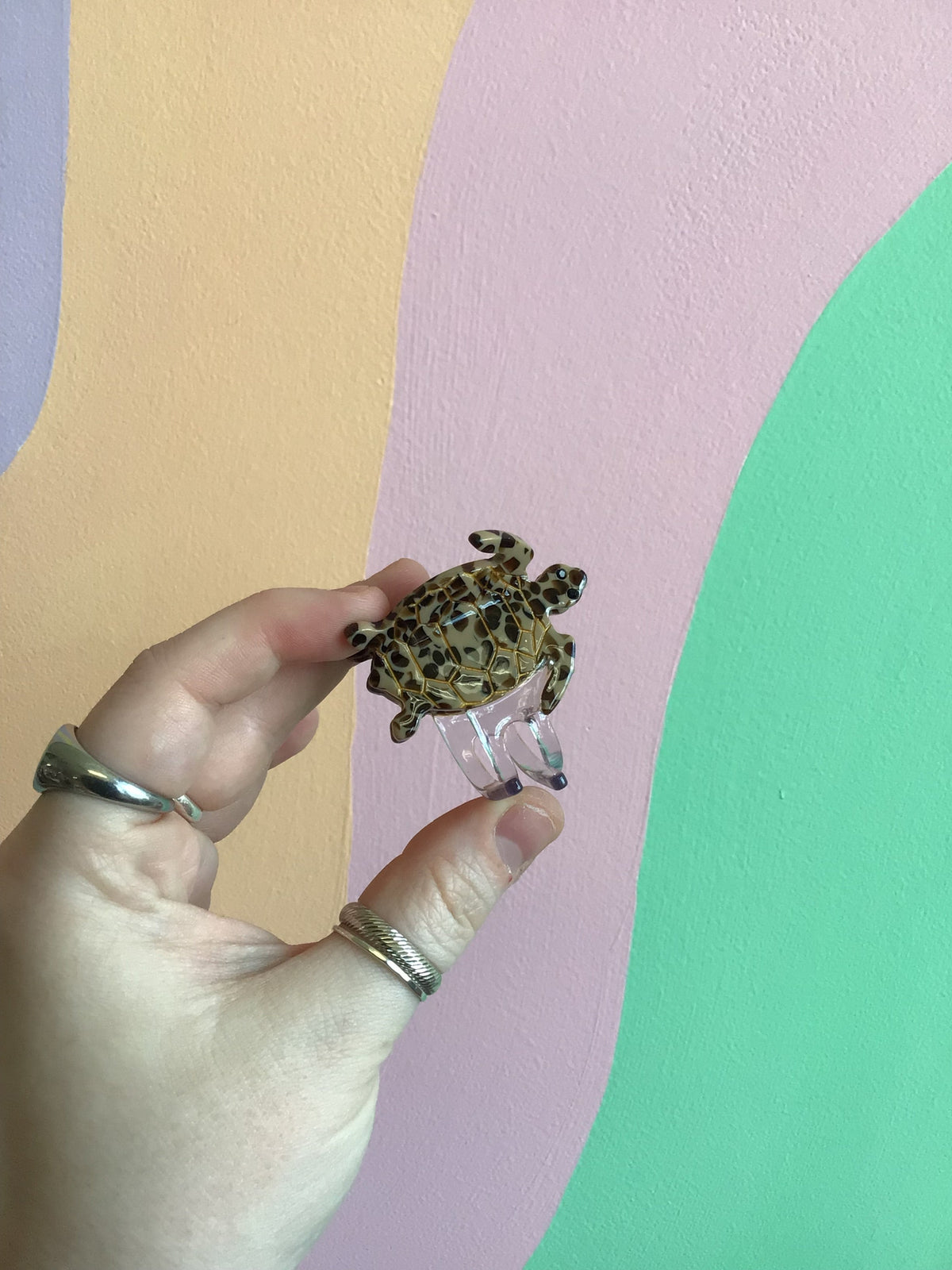 Brown-spotted turtle hair claw with textured shell and curved metal clips