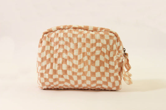 Handmade quilted pouch, peach-and-white checkered fabric, gathered top with tied tassel.