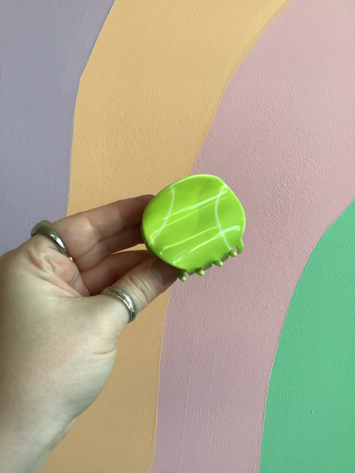 Neon green tennis ball–style hair claw clip with light seam lines