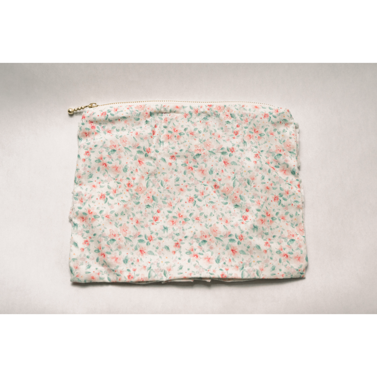 Pastel floral zip pouch clutch with top zipper and ruched trim