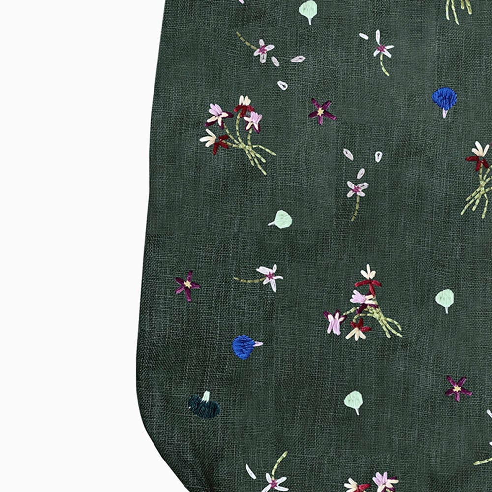 Dark green stocking with scattered colorful mushroom and flower embroidery detail