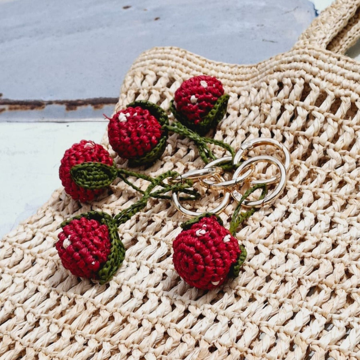 Raffia keyring with crochet strawberries and silver metal ring