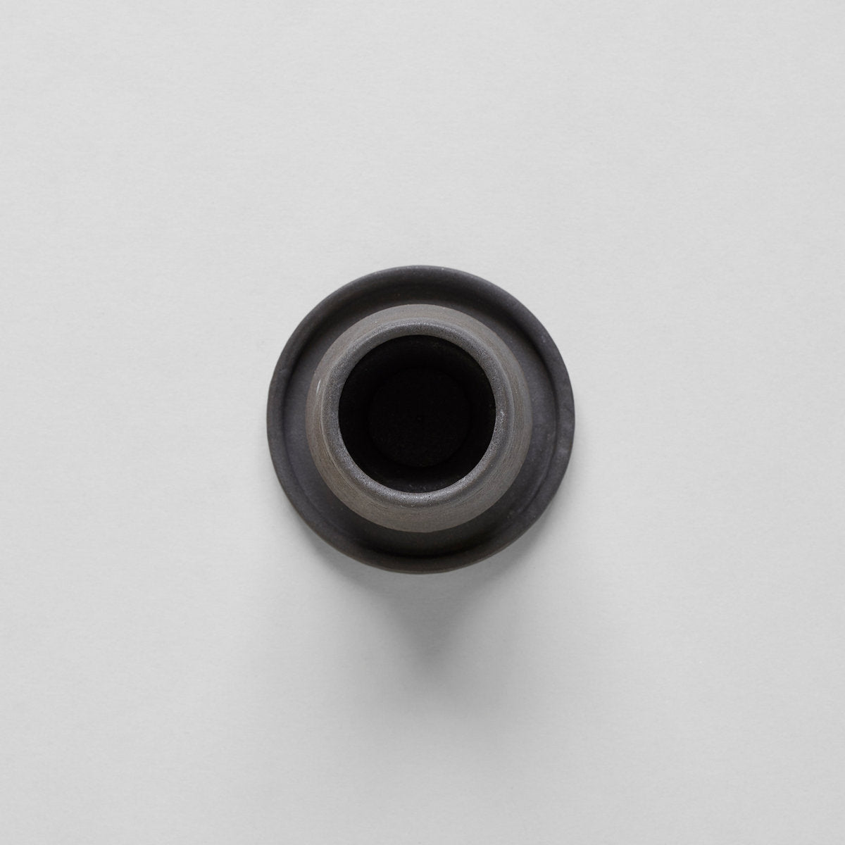 Stoneware match holder interior, dark opening with gray rim