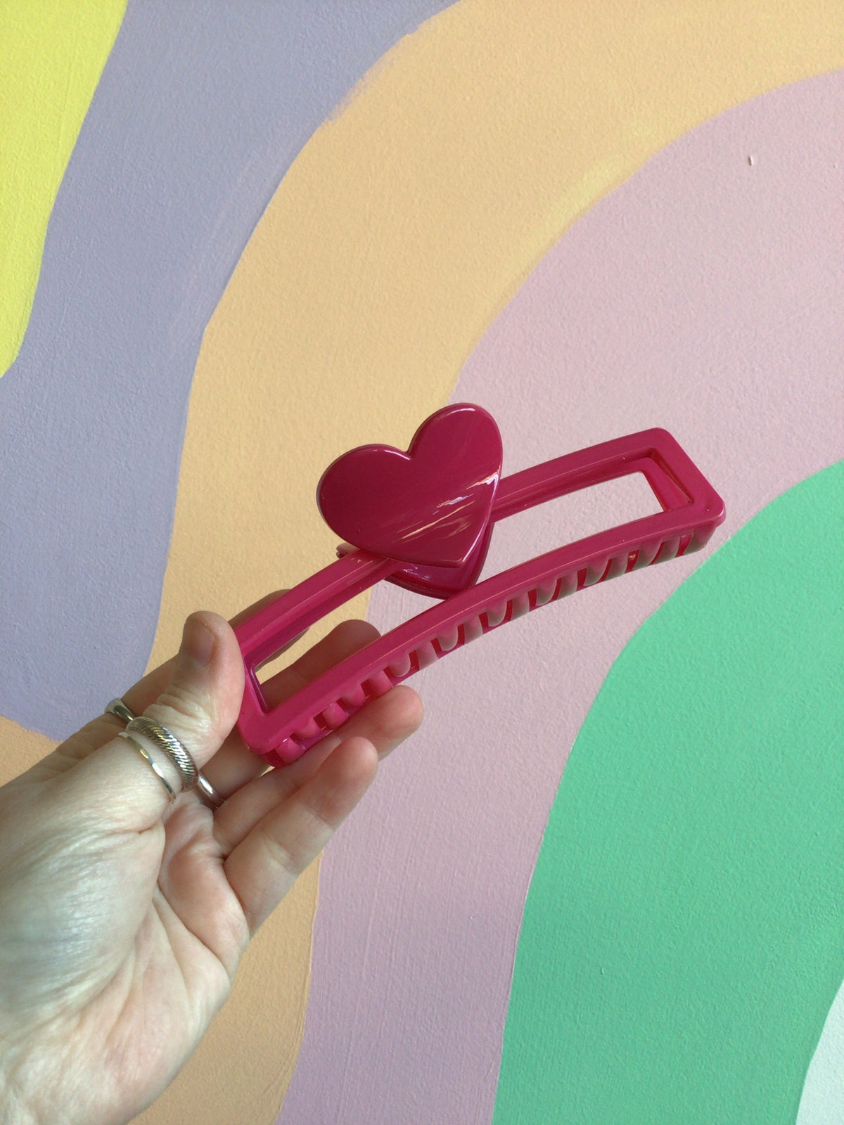 Pink heart hair claw with magenta clip and heart detail on top.