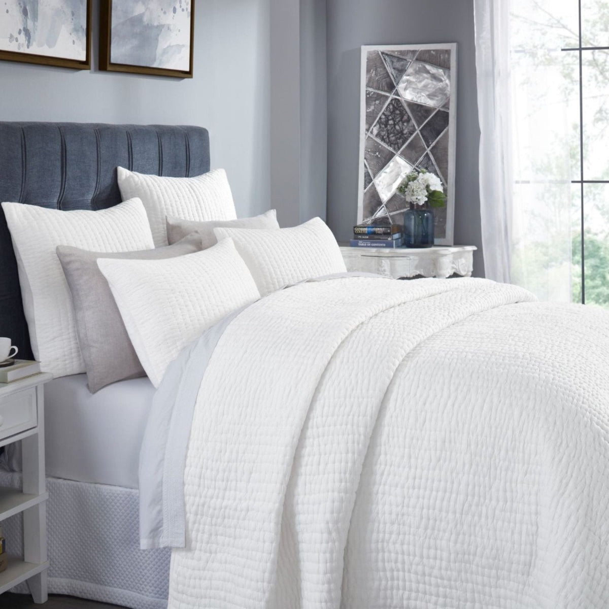 Off-white washed cotton quilt with textured crinkle weave, bed cover detail view