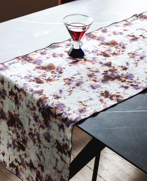 Marble-pattern table runner with white base and brown rose speckles, table overhang