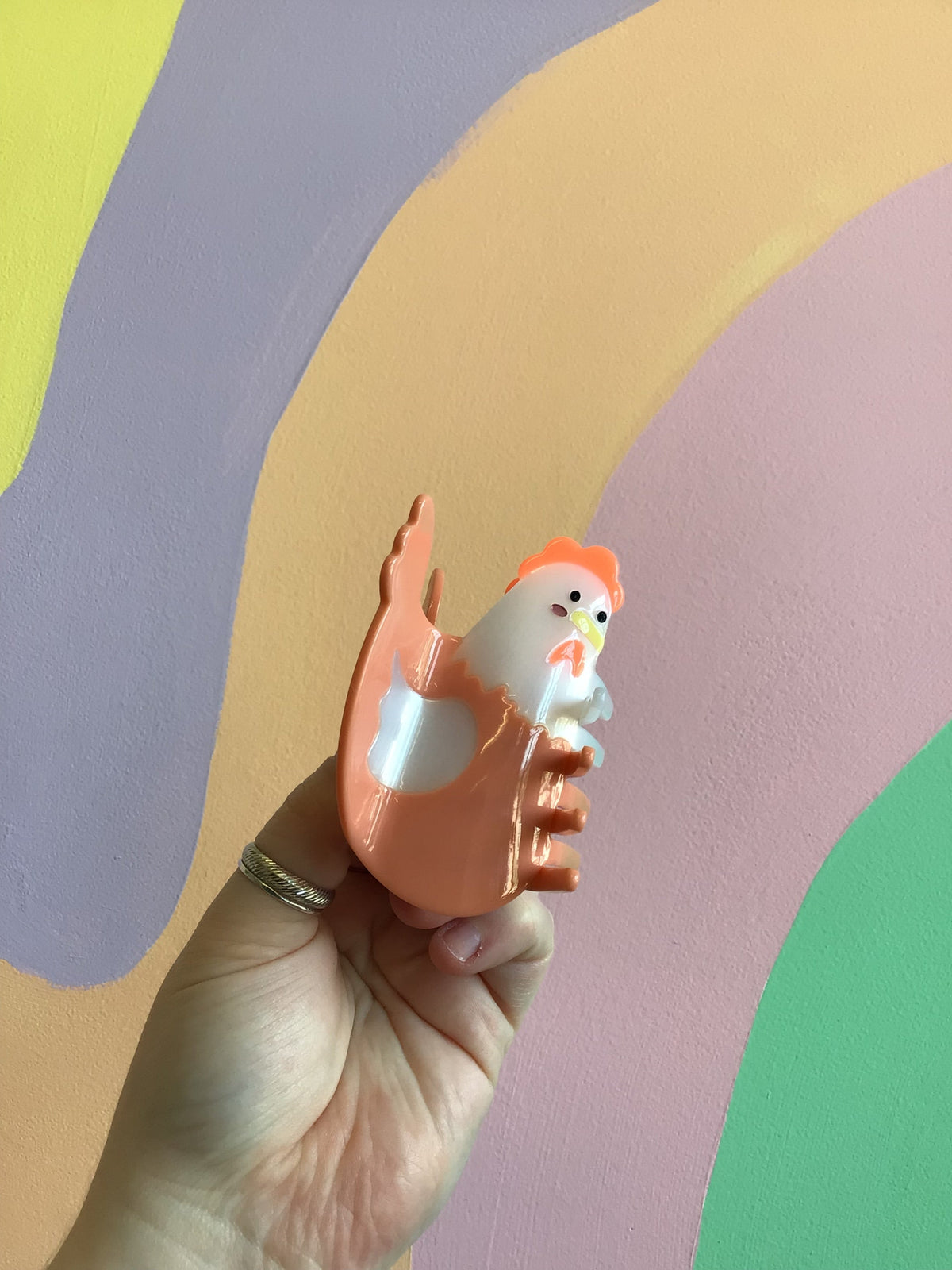 Orange pig hair claw with white muzzle and raised ears, glossy cartoon design