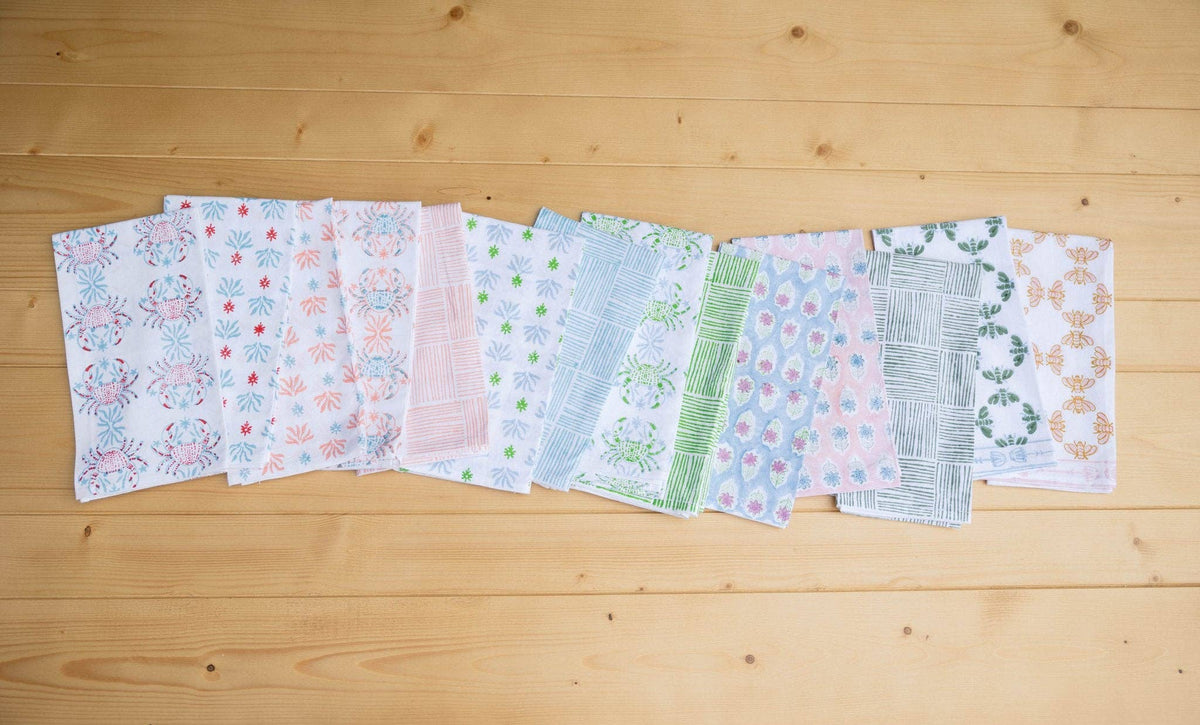 Tea towel with multi-color honeybee prints across folded panels