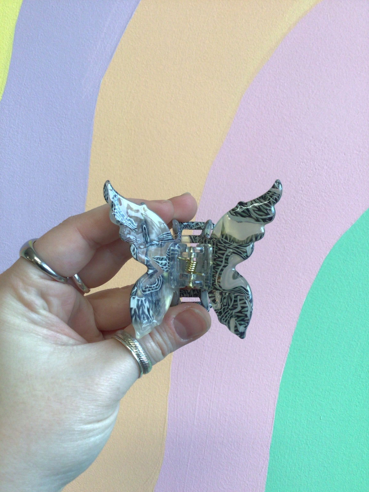 Butterfly hair claw with cool blue iridescent wings and metal hinged clip