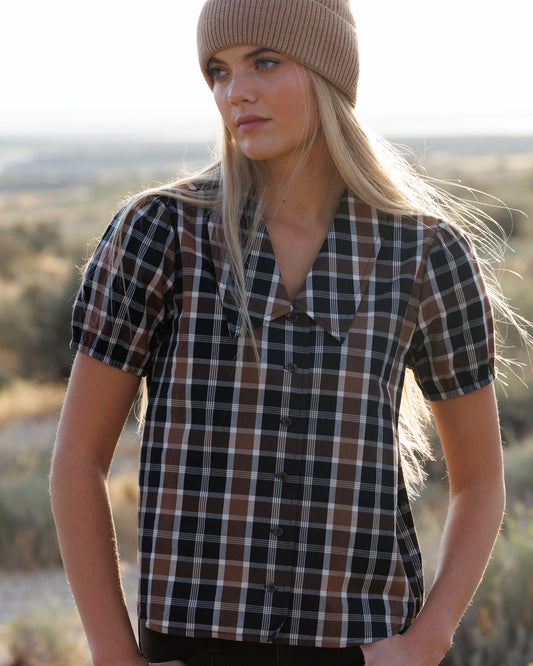 Short-sleeve plaid button-down shirt in dark tones with tan and white checks