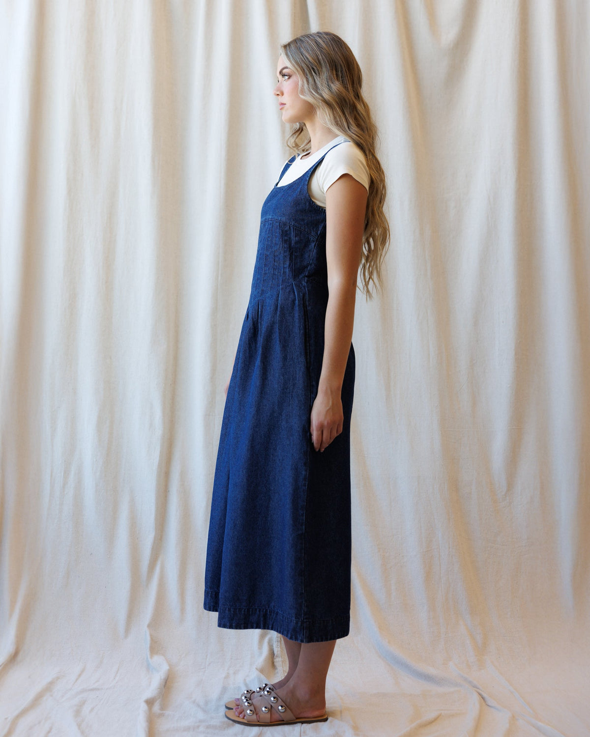 Sleeveless medium blue denim midi dress with square neckline and pleated gathered skirt
