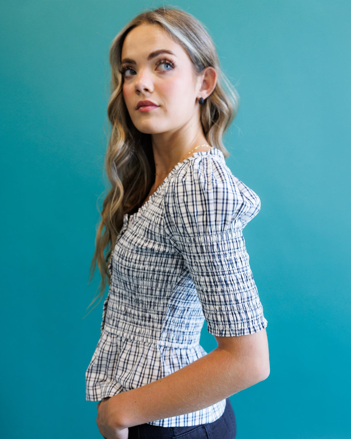 Plaid peplum blouse with puff sleeves and square neckline, side view