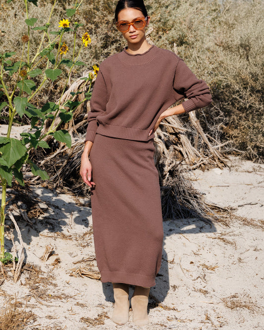 Brown knit midi skirt with ribbed waistband and hem, textured fabric