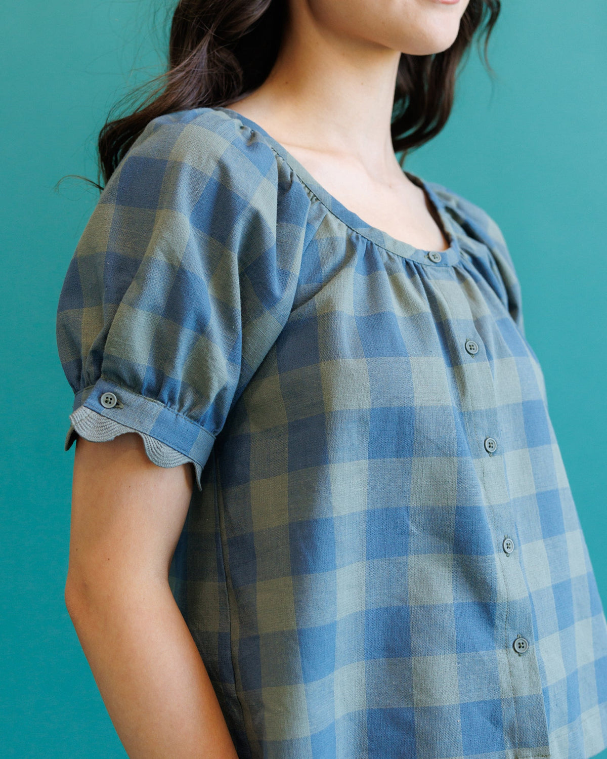 Blue checked short-sleeve top detail: puff sleeve with button cuff and button front
