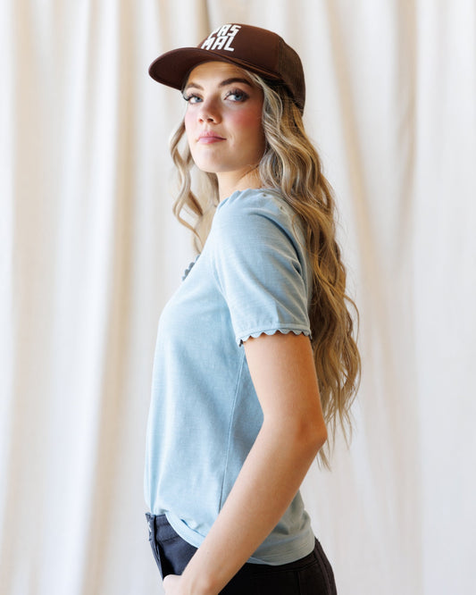 Light blue scallop-edge V-neck tee with short sleeves, side view