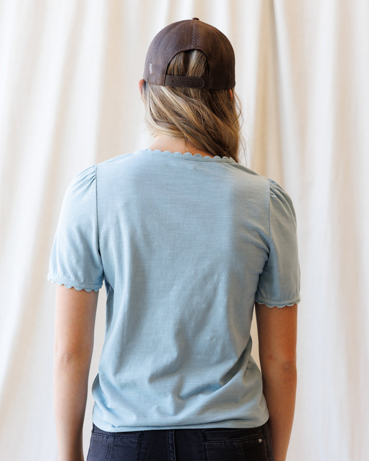 Light blue scallop-edge V-neck tee, back view with short sleeves