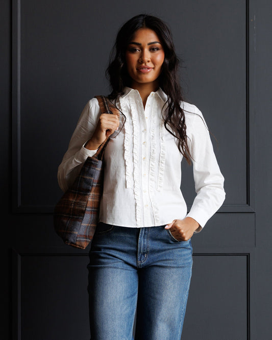 White ruffled-front button-down shirt with long sleeves and button placket