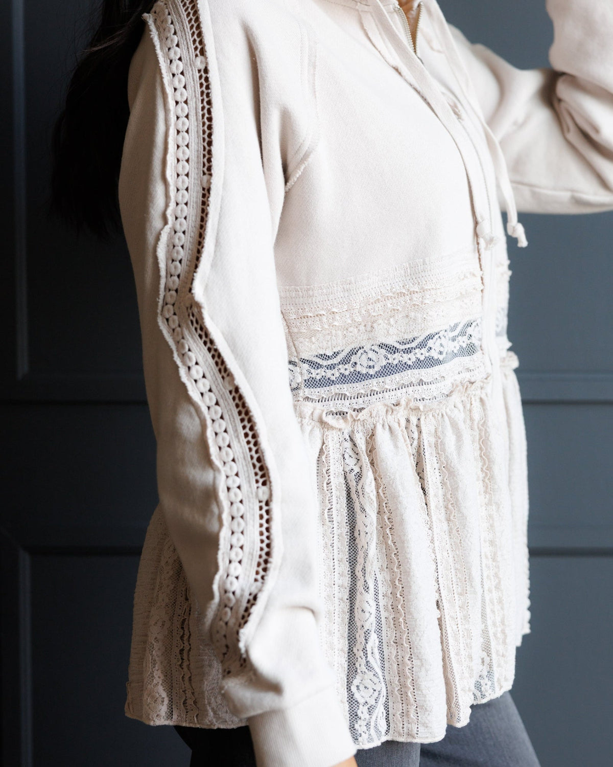 Ivory lace hoodie close-up of sleeve and tiered front panel