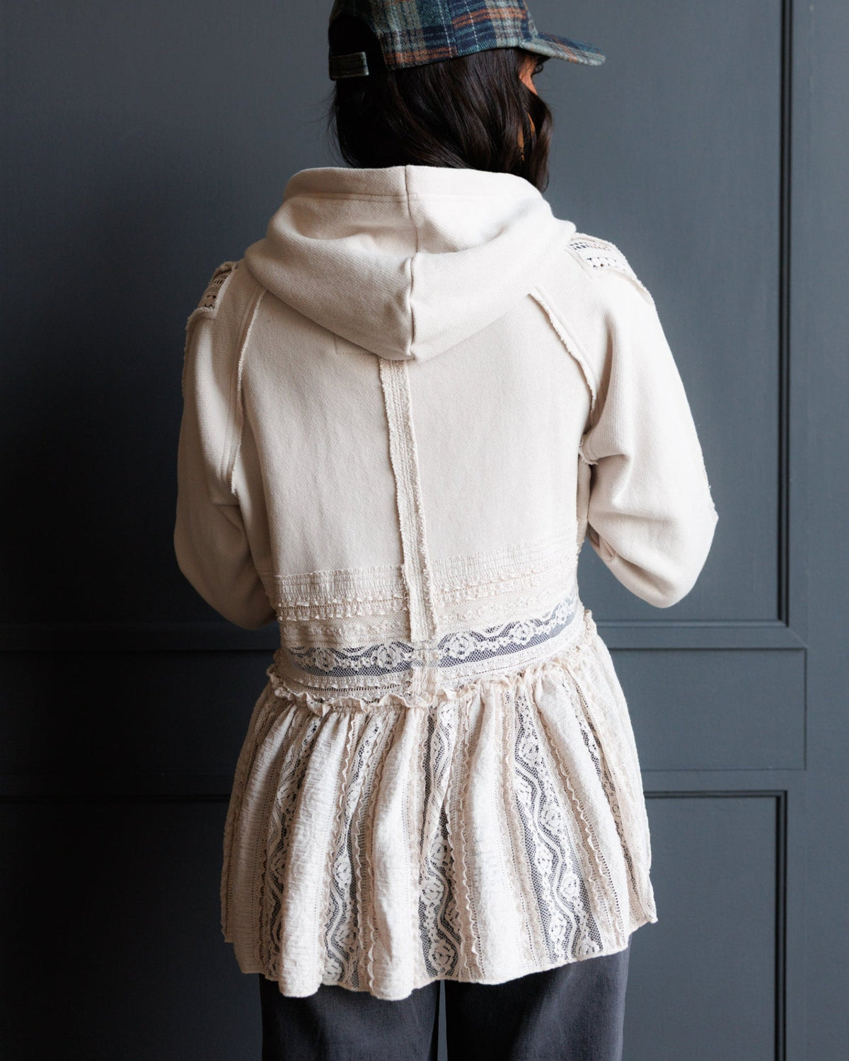 Back view ivory lace hoodie with drawstring hood and tiered lower panels