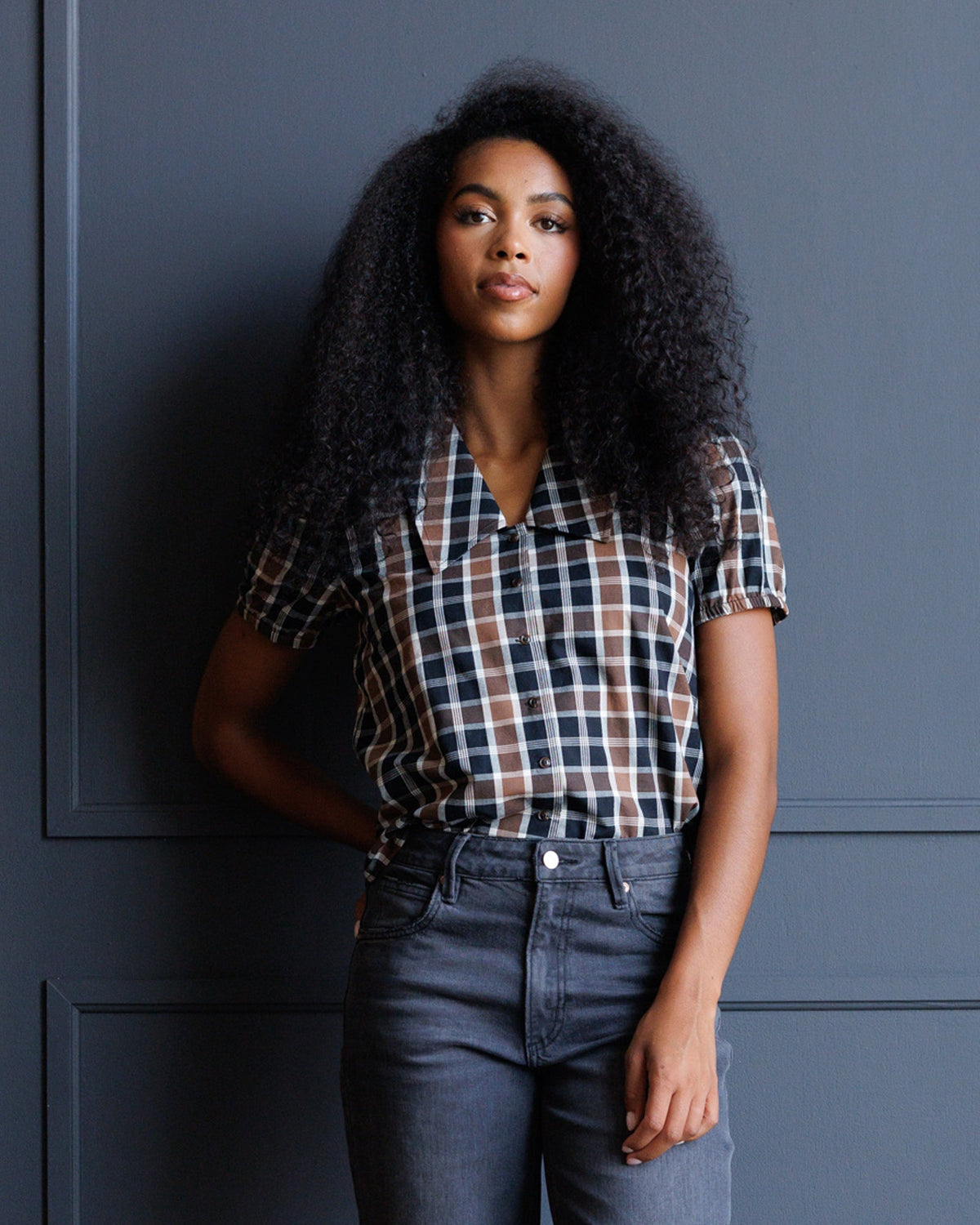 Black, tan, and white plaid short-sleeve button-down shirt with collar