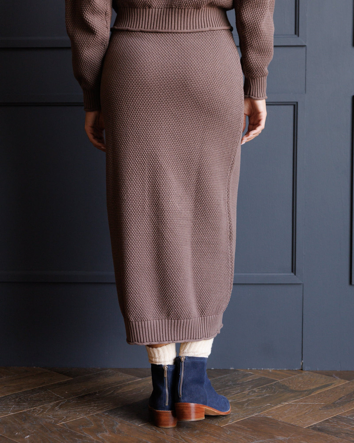 Brown knit midi skirt with ribbed waistband and hem, textured knit finish