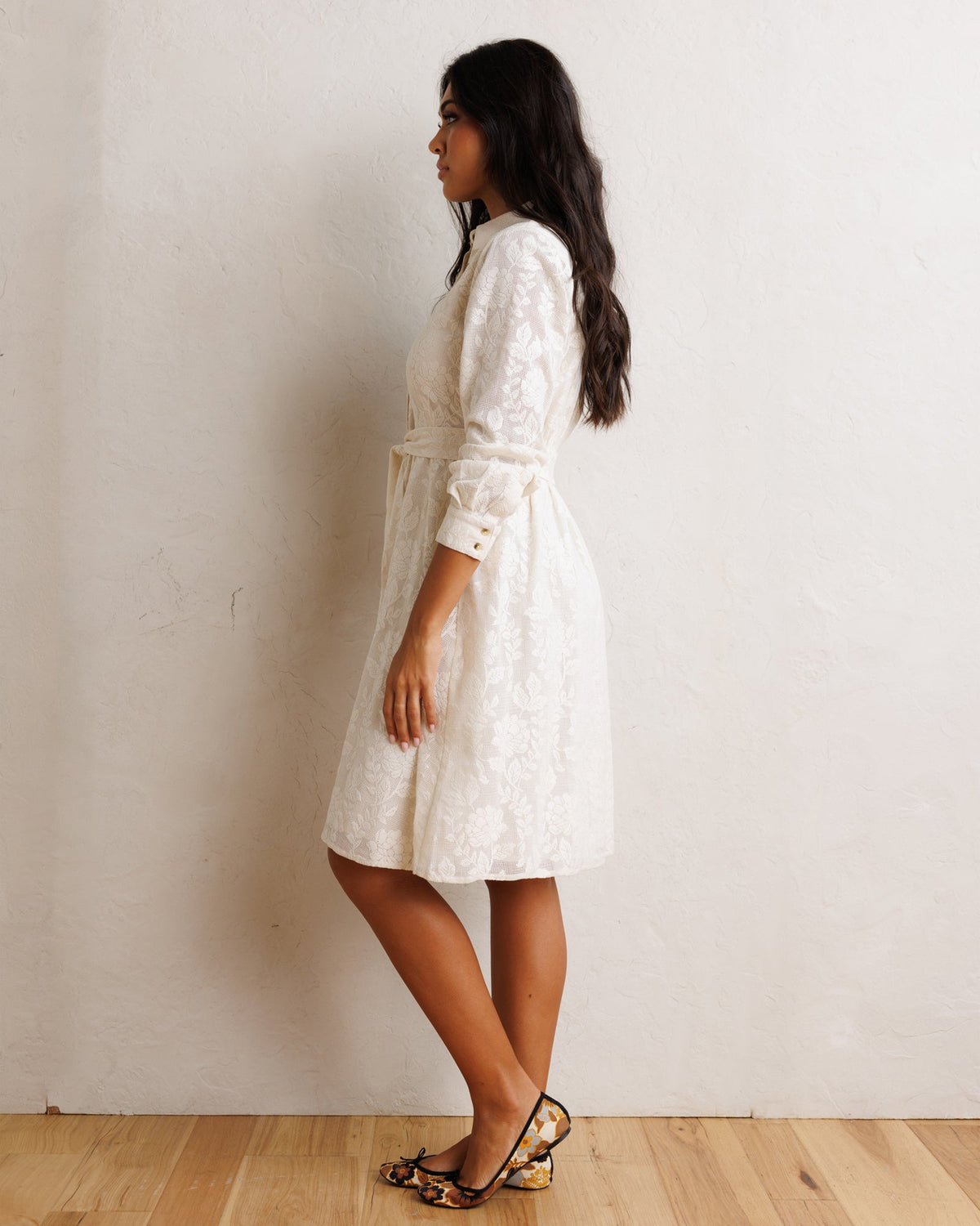 White long-sleeve shirt dress with button cuffs and tied waist, midi length