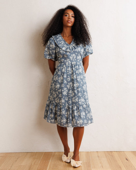 Blue floral midi dress with ruffled V neckline, puff sleeves, tiered skirt