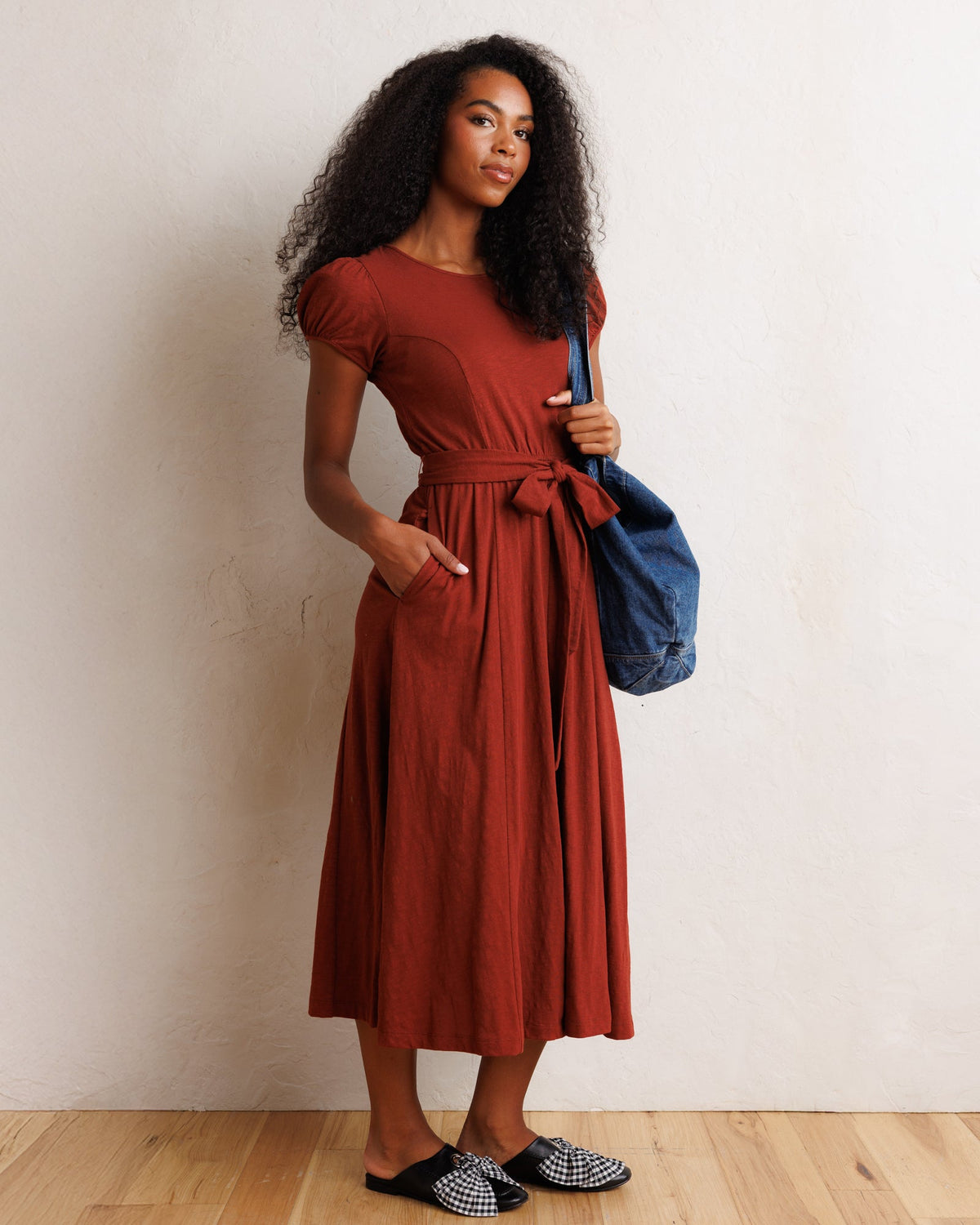 Rust short-sleeve midi dress with tied waist and flowing skirt