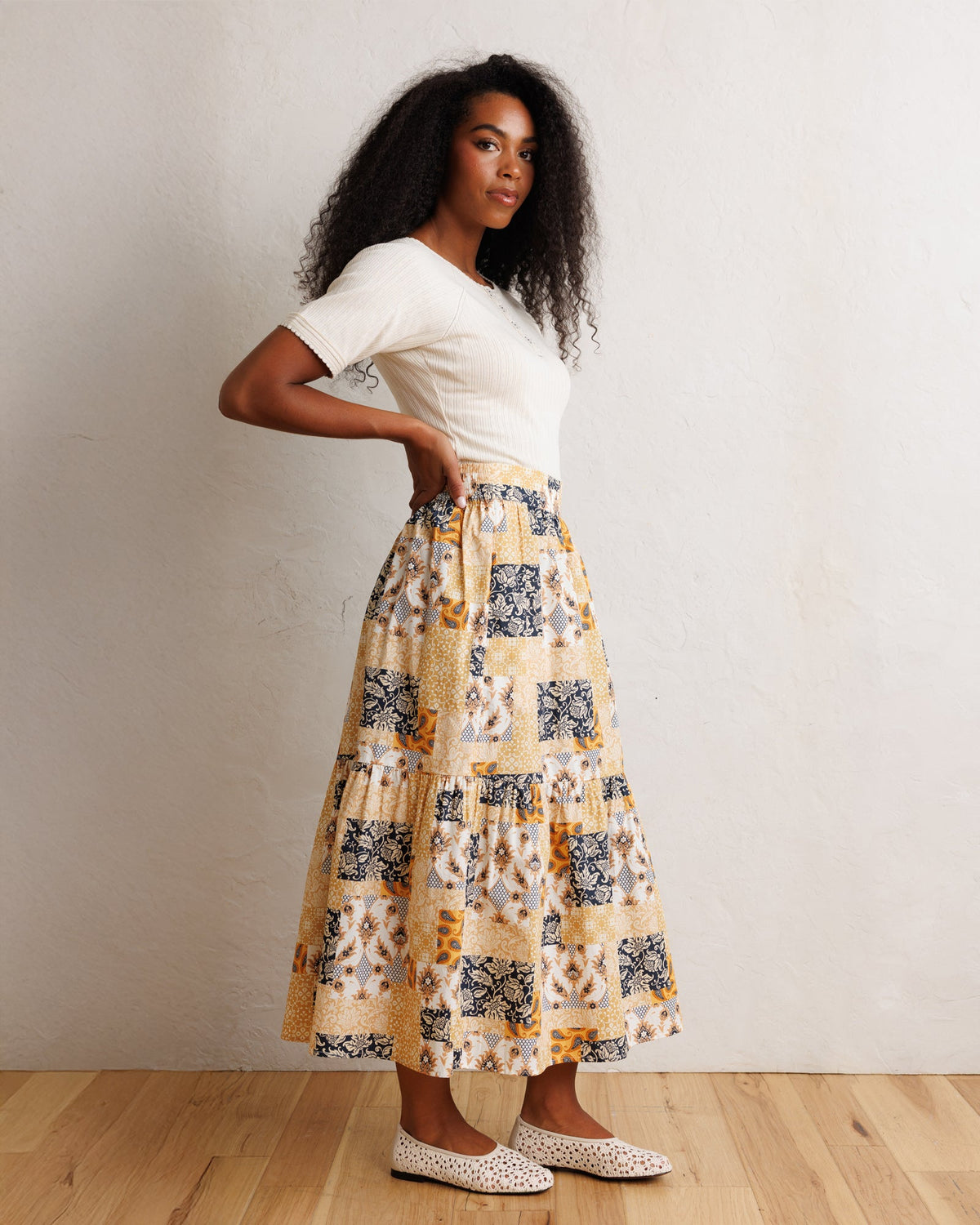 Tiered patchwork midi skirt with elastic waist, orange-cream and navy print blocks