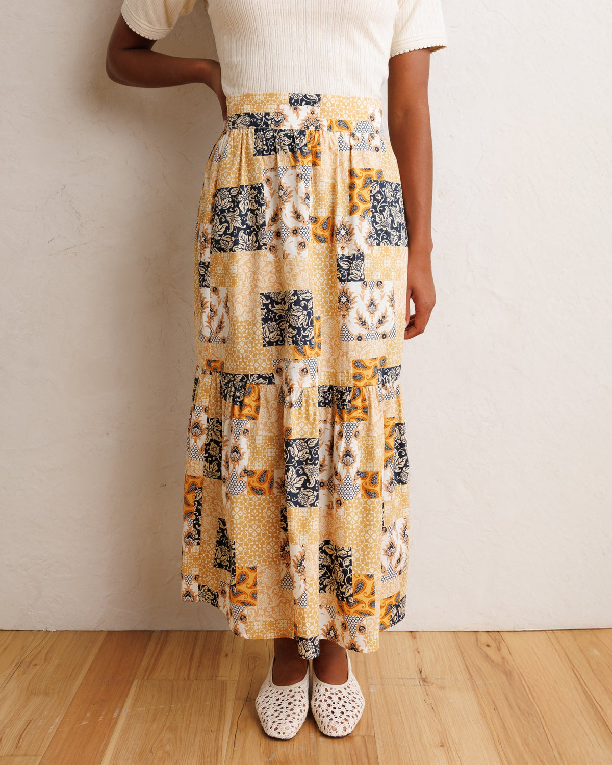 Patchwork midi skirt with tiered ruffles in orange, cream, and navy printed panels